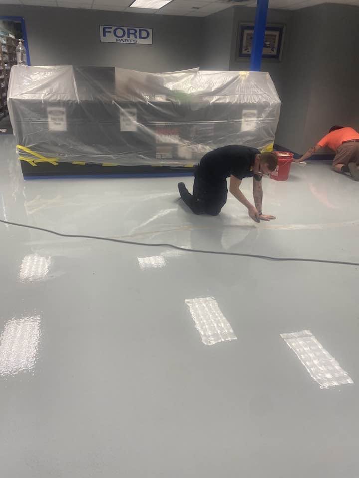 Quality Hardwood Floors crew applying the new floor at Ford